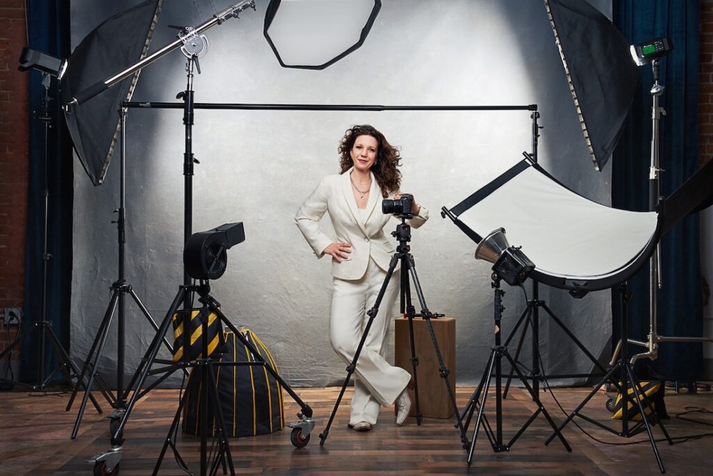 Christina Gressianu in her studio in downtown Loveland, camera on a tripod beside her